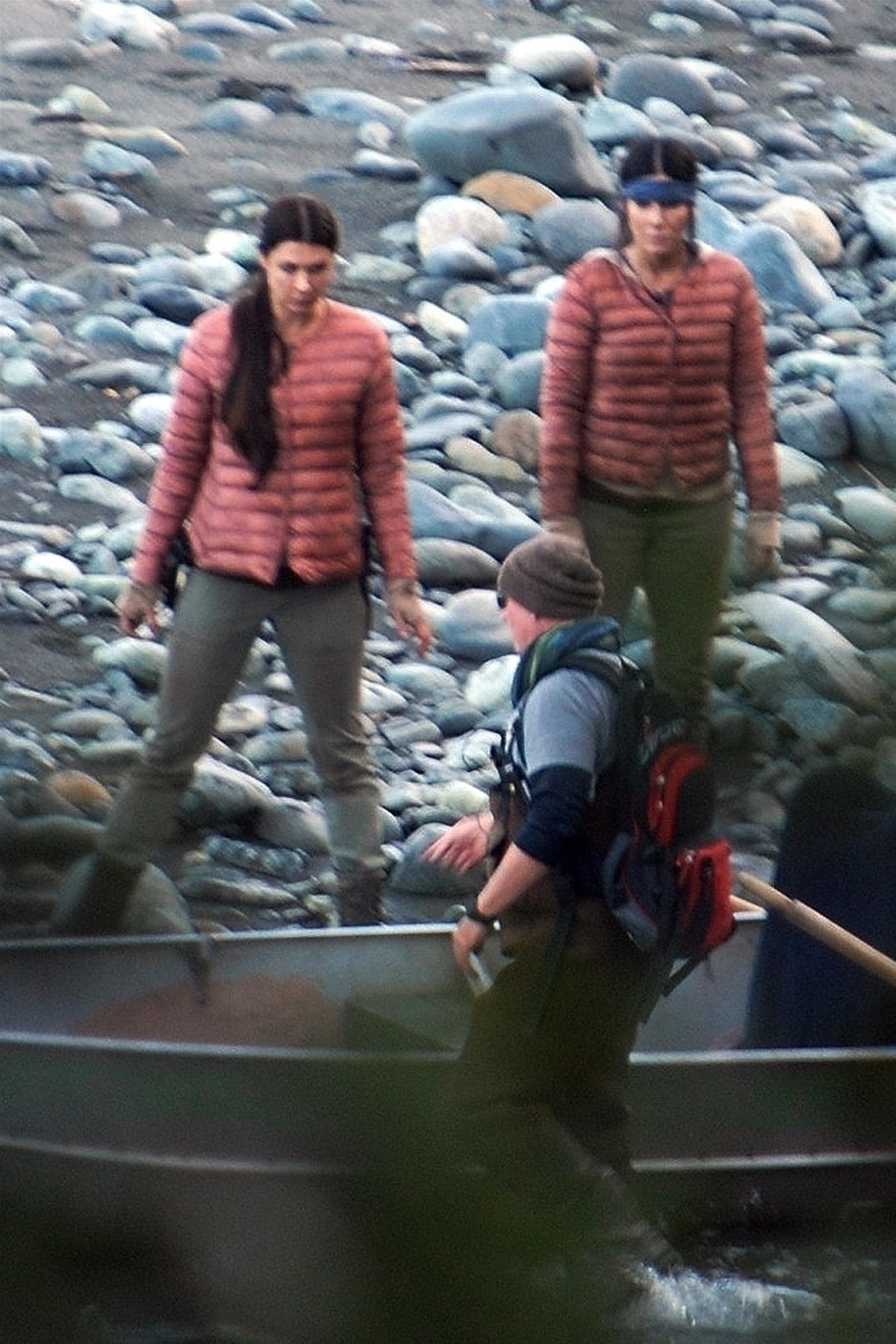 Sandra Bullock and her stunt double wearing red coats while filming