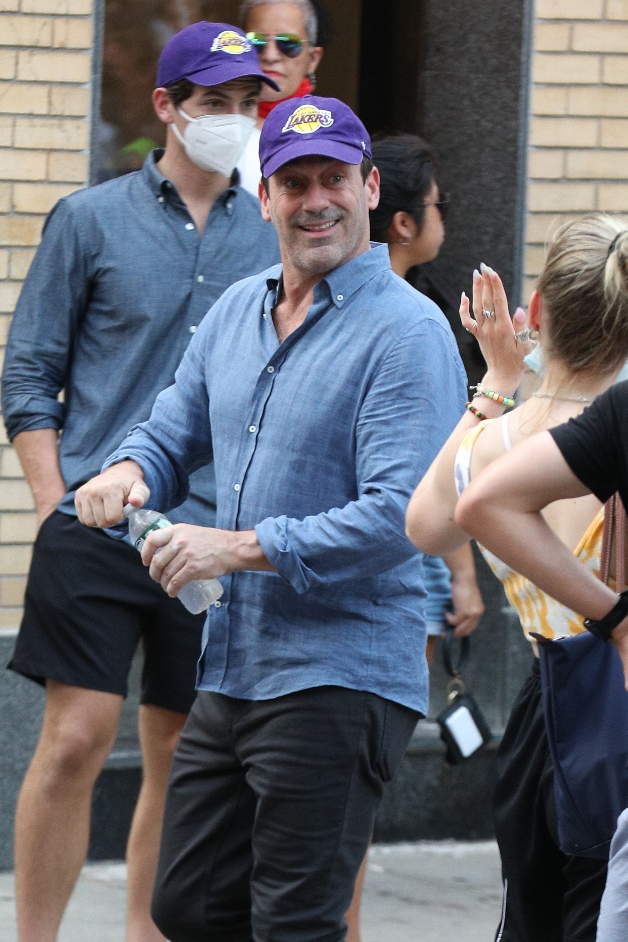 Jon Hamm and his stunt double wearing a lakers hat while filming