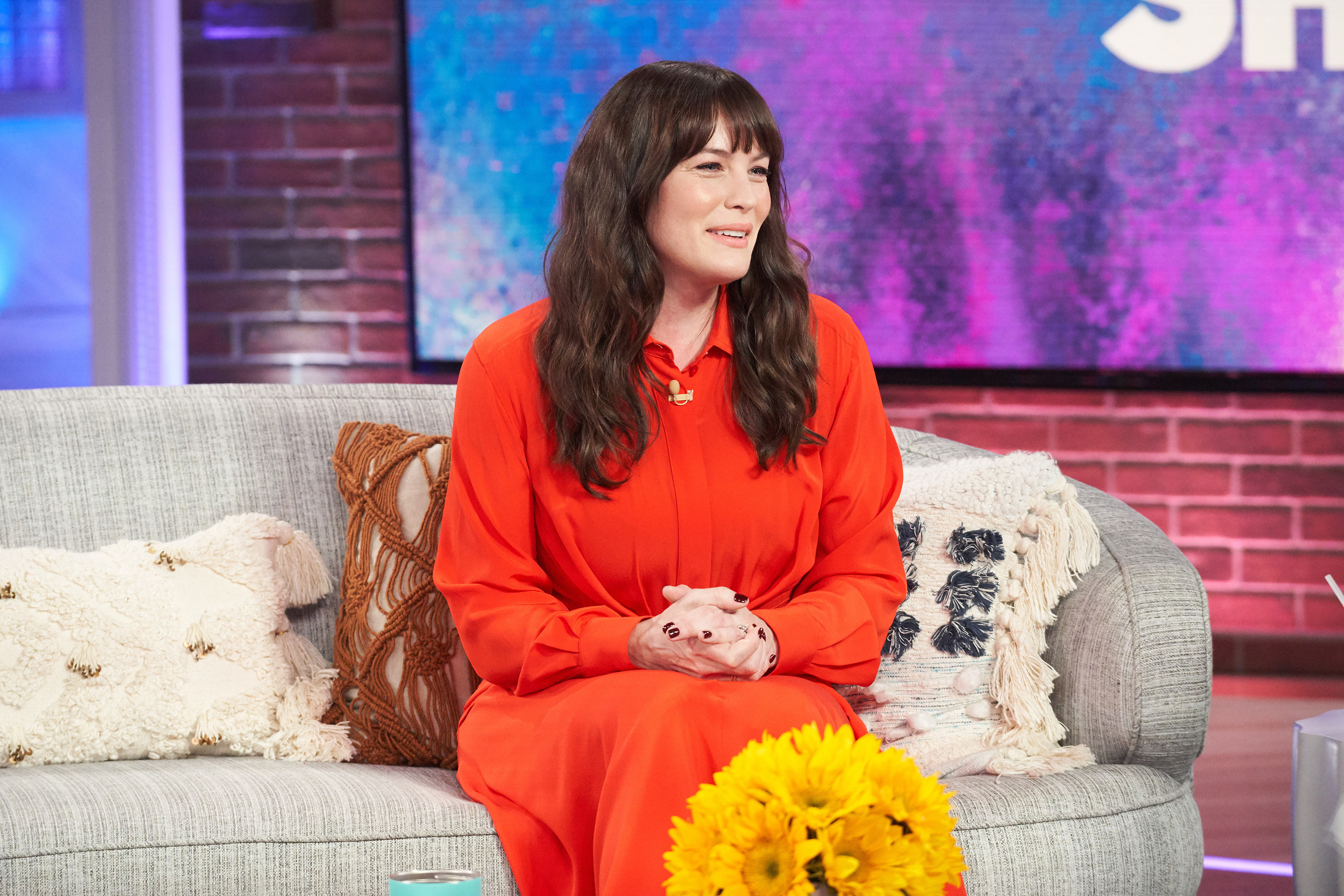 Liv Tyler in an orange dress