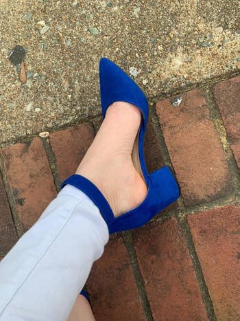Reviewer wears same style pump in a dark blue shade with skinny gray pants