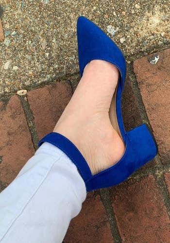 Reviewer wears same style pump in a dark blue shade with skinny gray pants