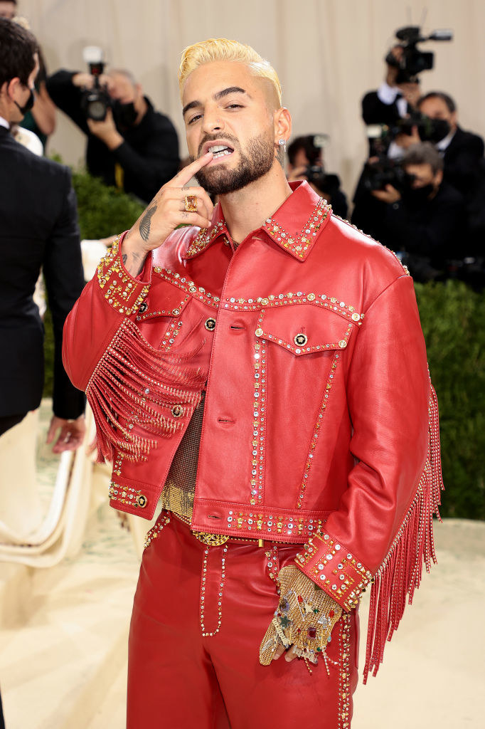 Maluma wearing a brightly colored leather jacket and pants ensemble with fringed sleeves at the MET Gala