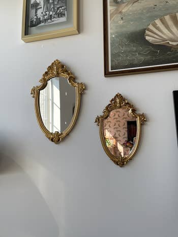 pair of mirrors hanging on gallery wall