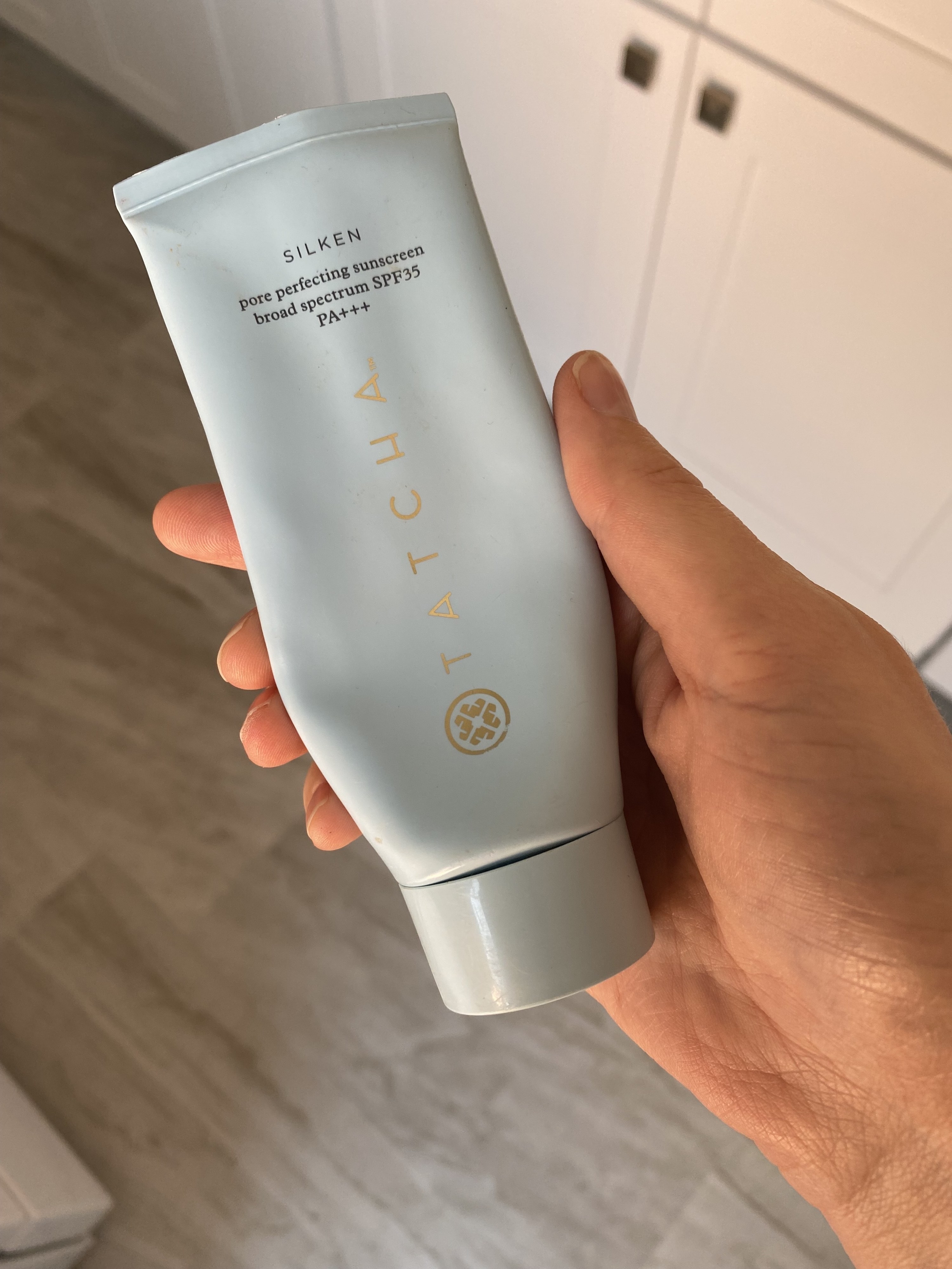 The 3oz bottle of Tatcha sunscreen in my hand
