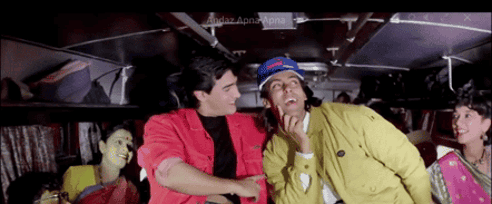GIF of Prem and Amar dancing to Do Mastane in the bus with other passengers