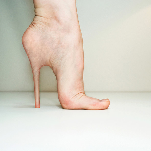 bare foot with a high heel coming out of the heel flesh