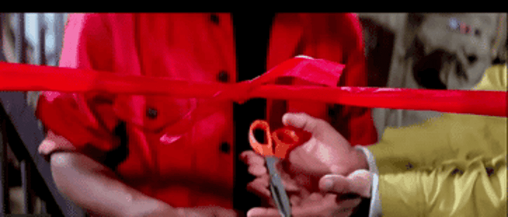GIF of Amar inaugurating a prison door while crying as the police and Prem clap