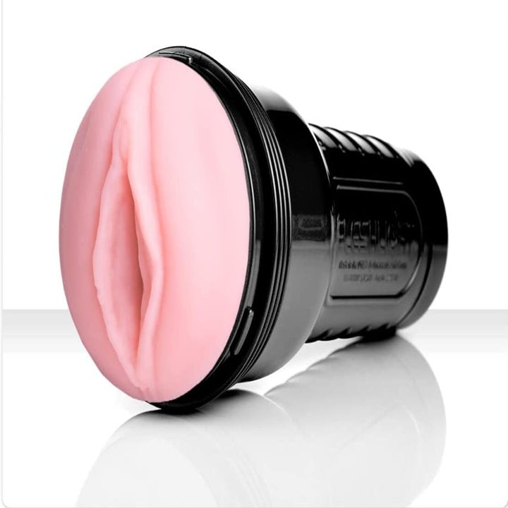 The Fleshlight with a handle on one end and a pink opening on top