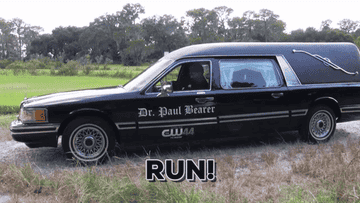 two men running from a hearse