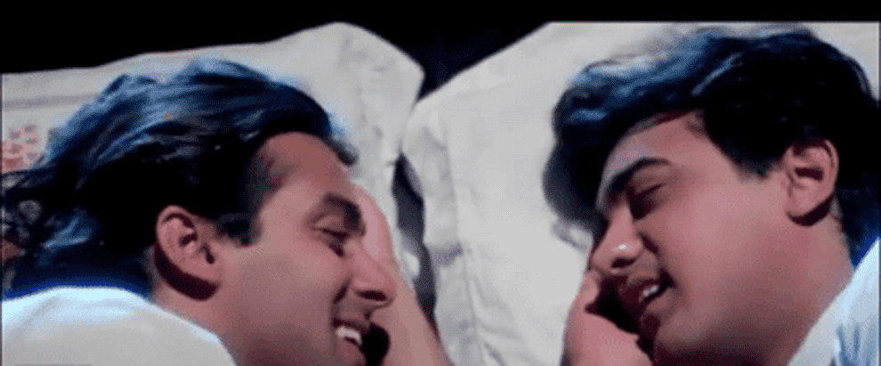 A GIF of Amar and Prem sleep talking to each other before realising that it&#x27;s not a dream