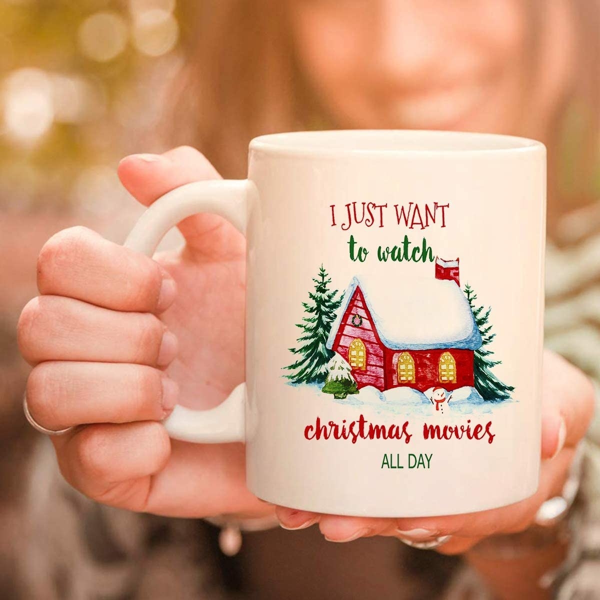 The mug with a snow-covered house and text I just want to watch christmas movies all day