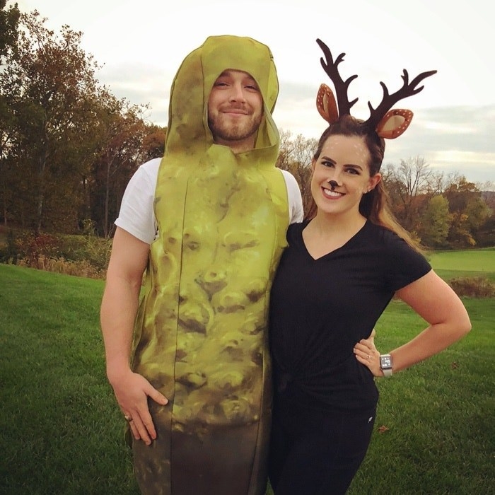 A man in a pickle costume and his partner dressed as a doe