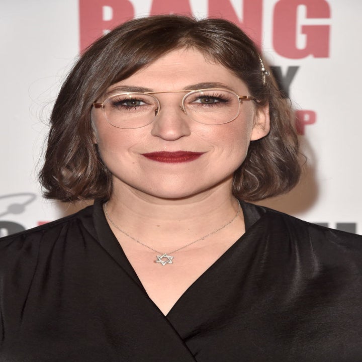 Mayim posing at an event
