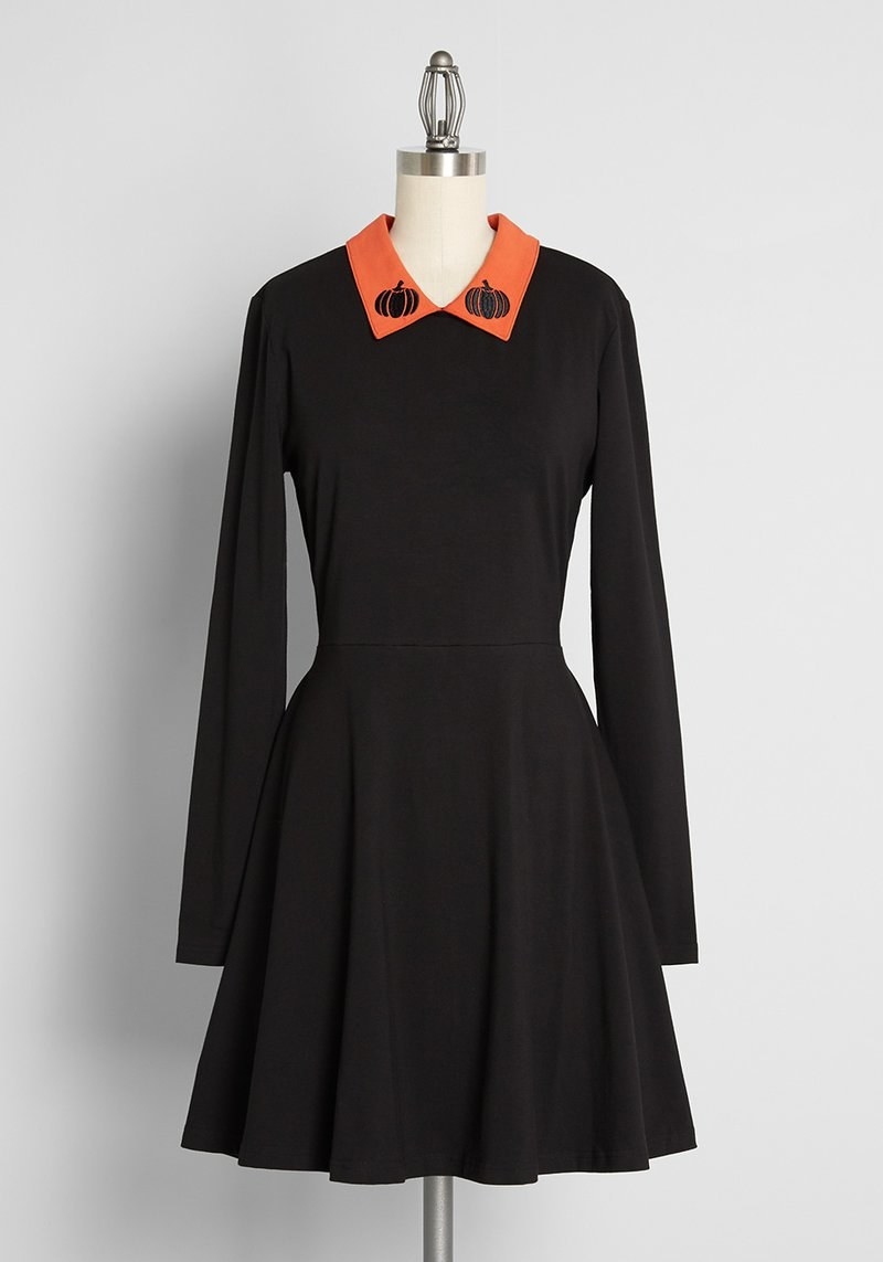 the black dress with an orange collar with pumpkins on it
