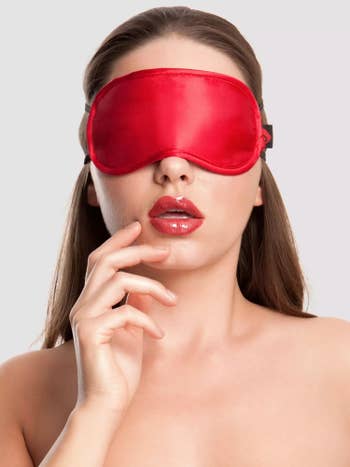 Model wearing red satin blindfold