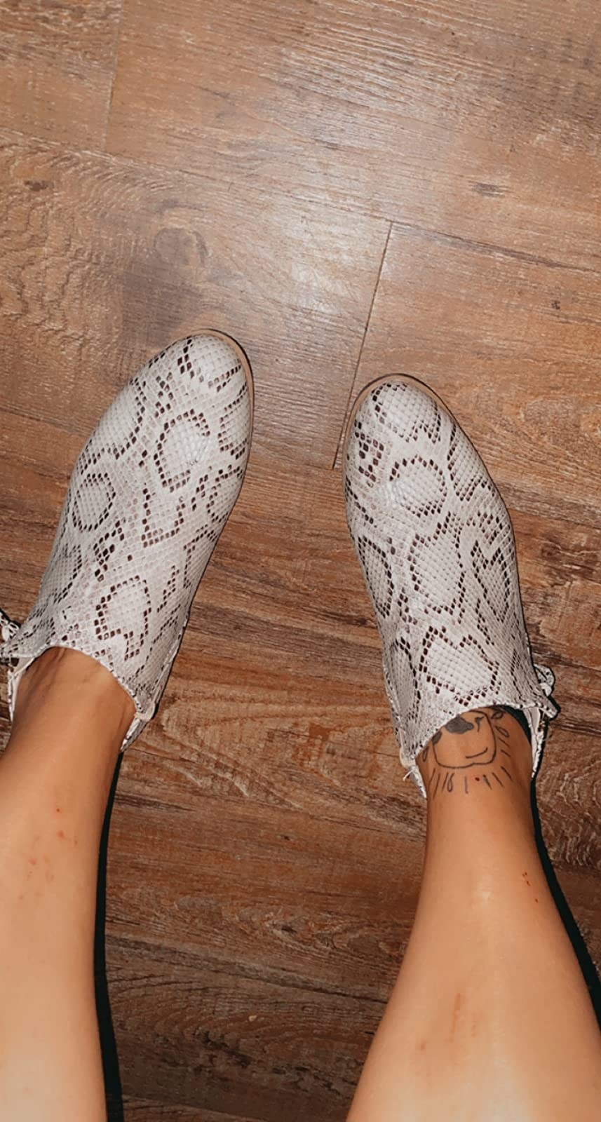 reviewer in white and black faux-snakeskin booties