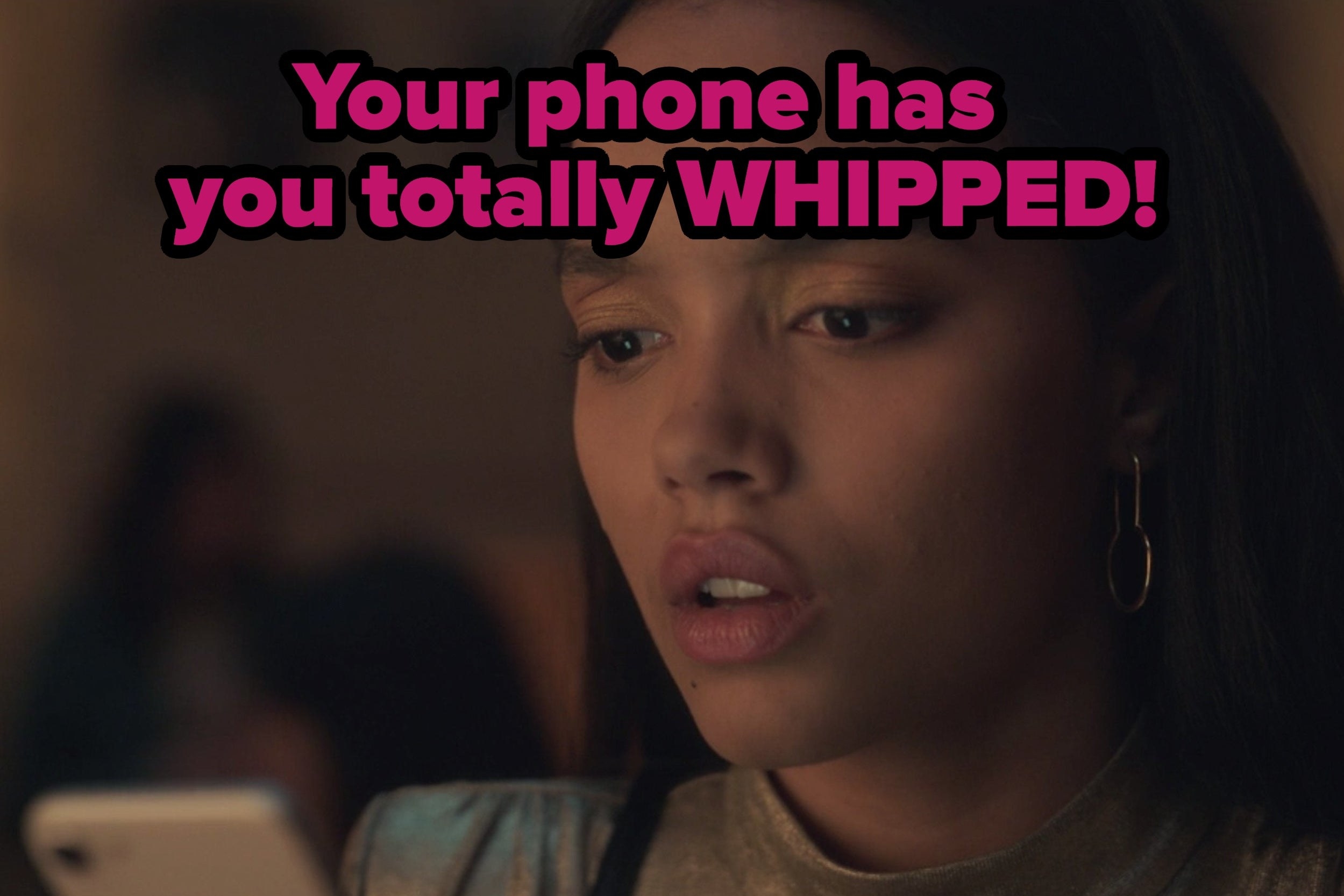Gossip Girl girl looking at phone and the words: your phone has you totally whipped!