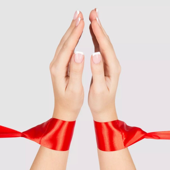 Model wearing red ribbon restraints
