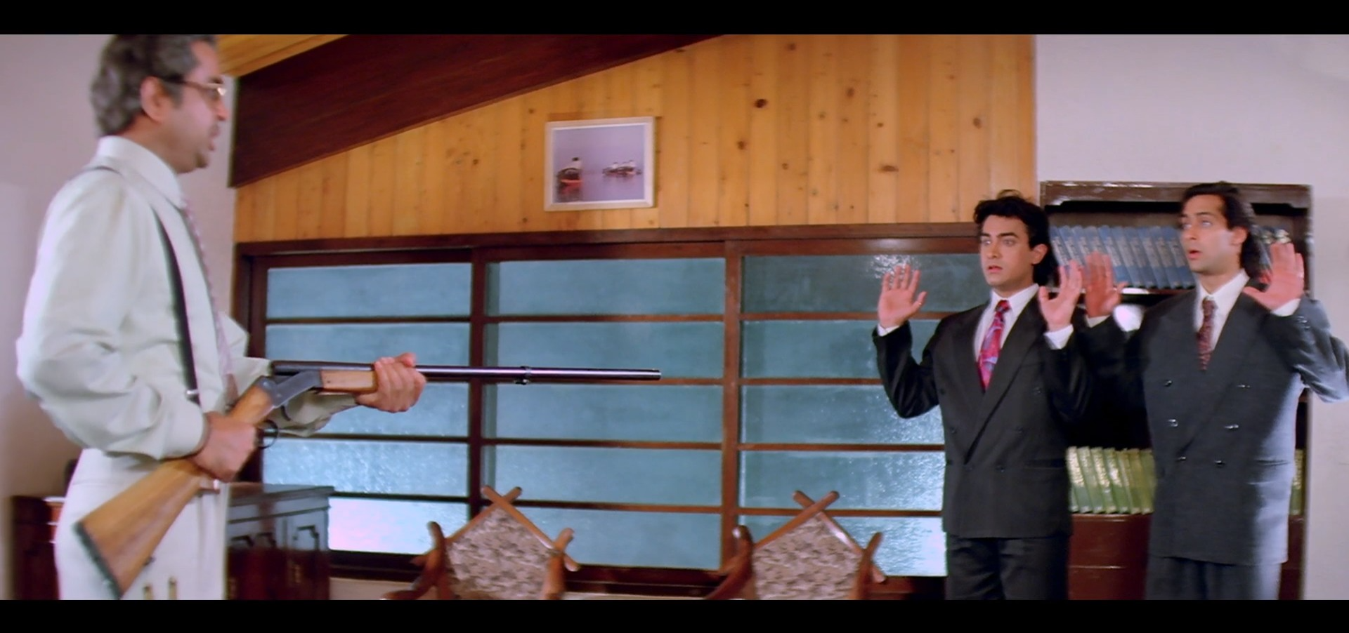 Ram Gopal holding a gun towards Prem and Amar