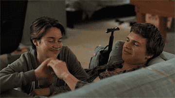 Hazel Grace and Augustus holding hands in the hospital