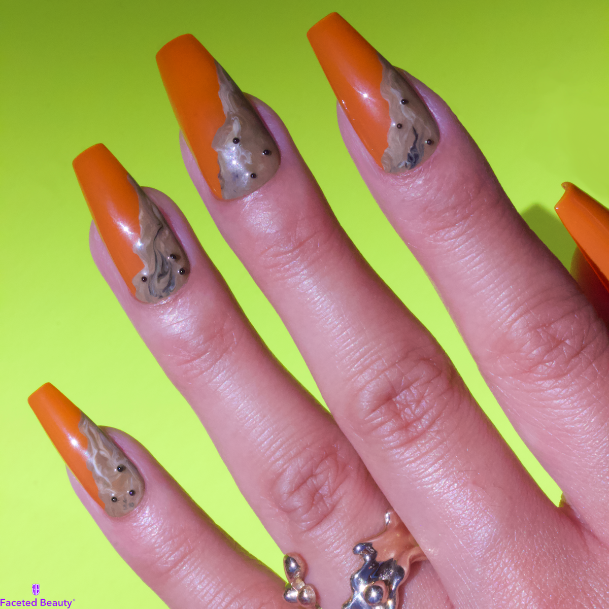 Orange coffin-shaped nails with brown sugar milk tea in bottom half