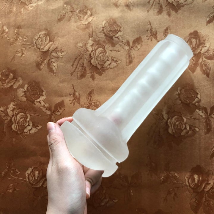 A reviewer holding the masturbator