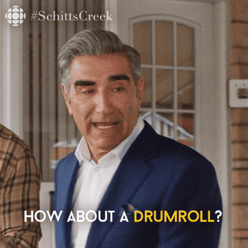 A GIF of Eugene Levy as Johnny Rose saying &#x27;How about a drumroll?&#x27;
