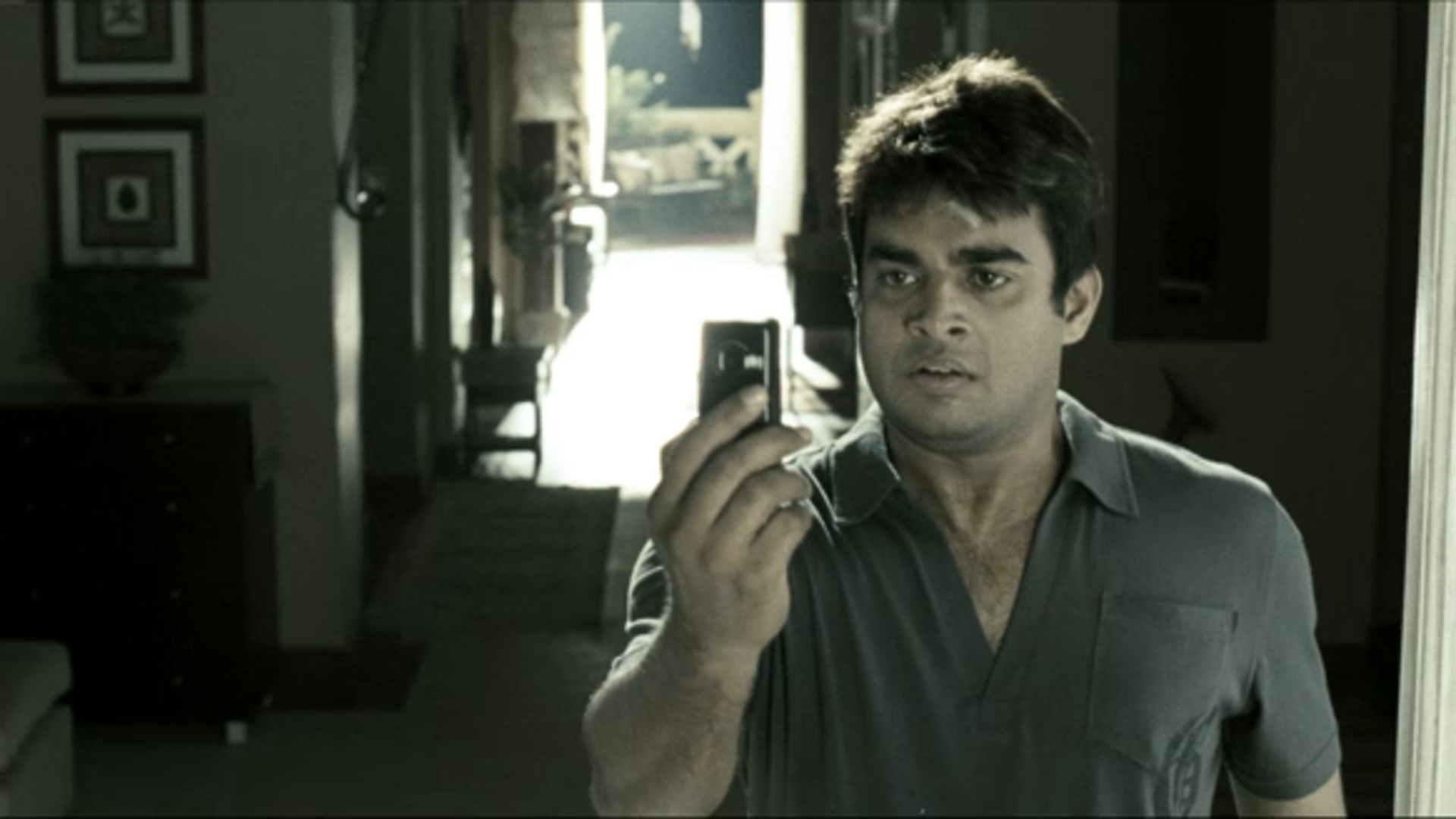 Still of Madhavan from the movie, looking into a phone