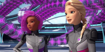 two barbie characters wear space-like superhero suits while aboard a spaceship