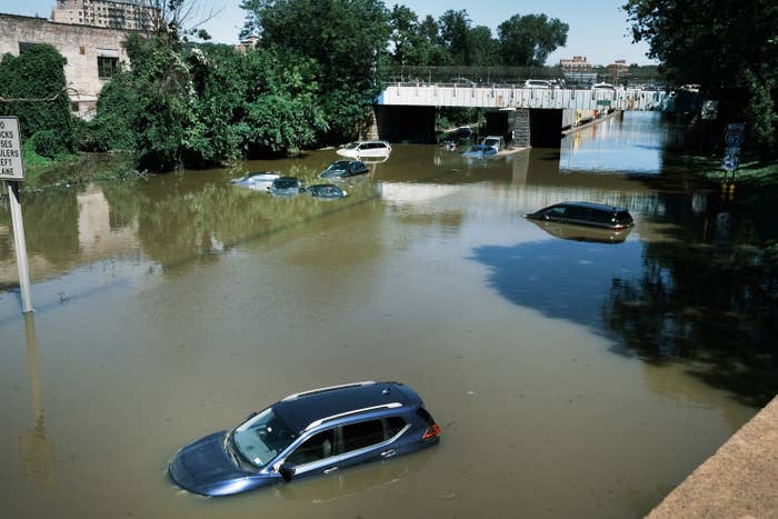 Cars are shown submerged by water on a flooded highway