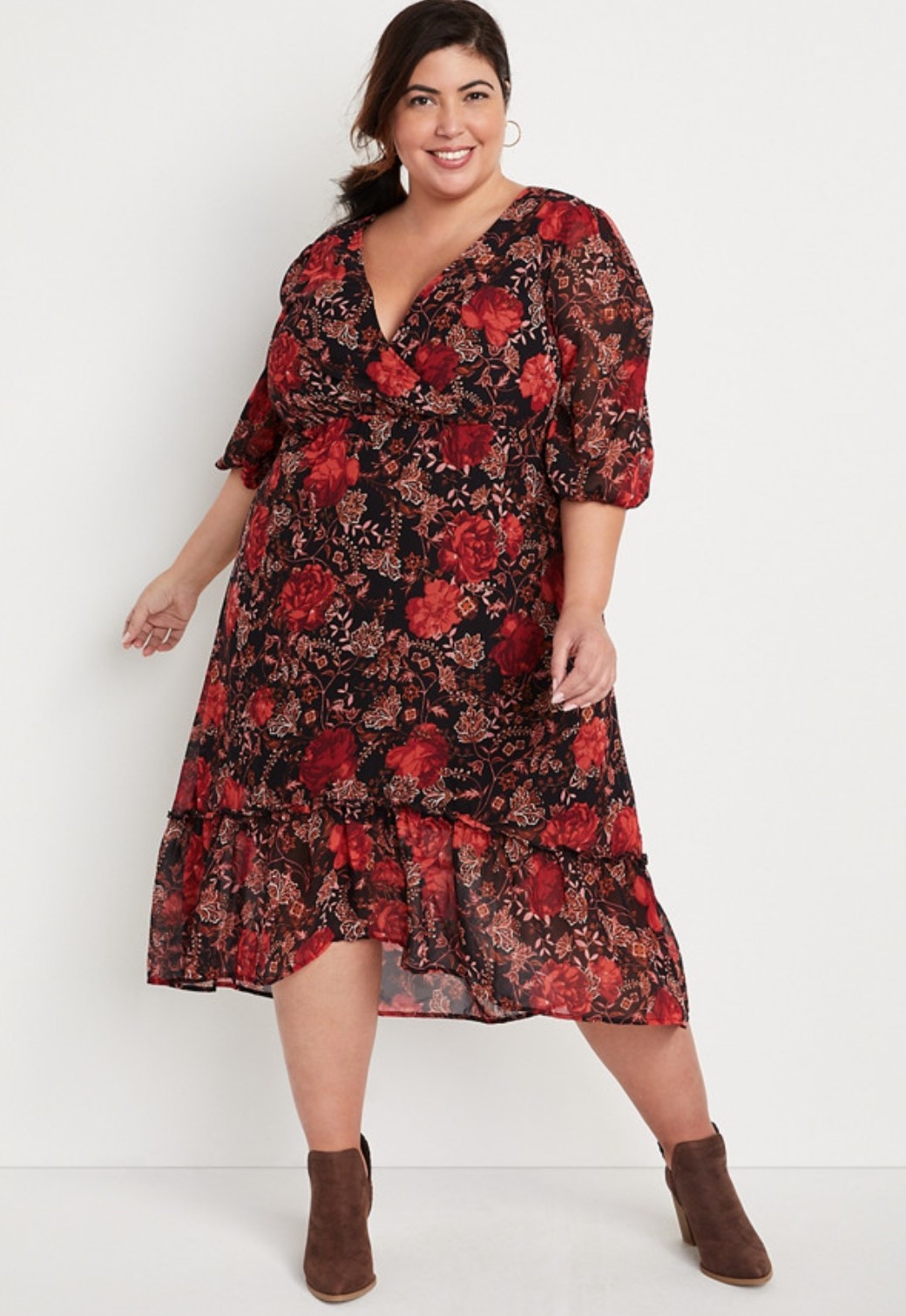 model wearing the floral dress with brown ankle booties