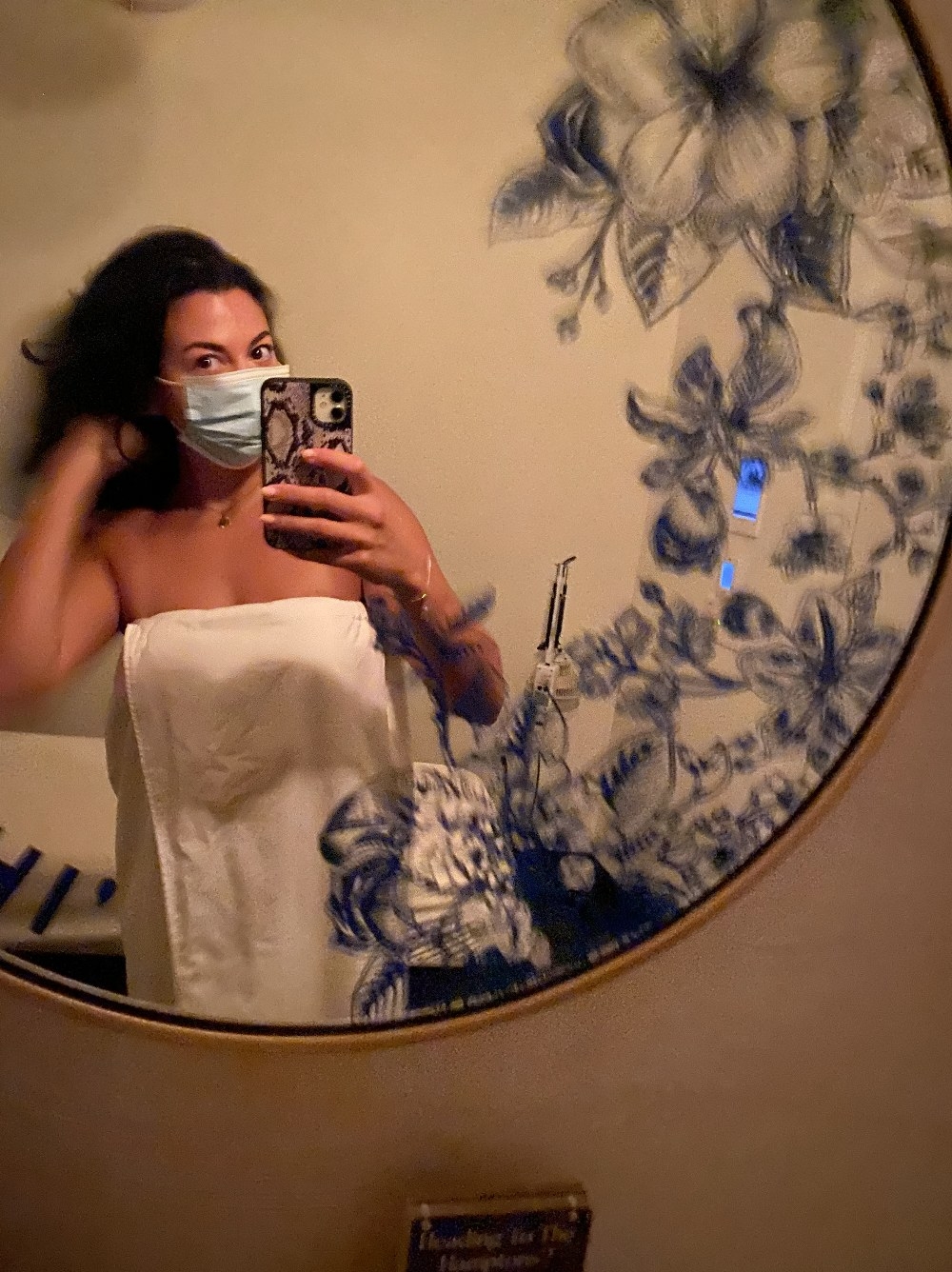 An image of the author in a towel taking a selfie in the mirror