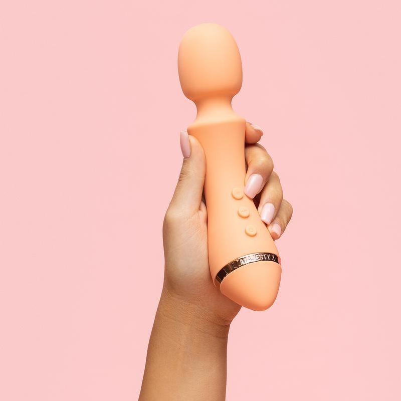 Model holding orange wand vibrator