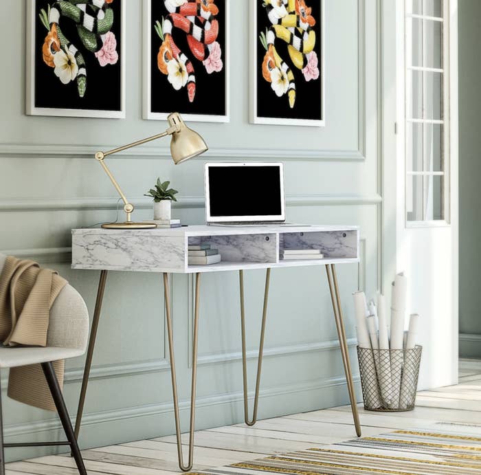 a marbled desk with gold hairpin legs