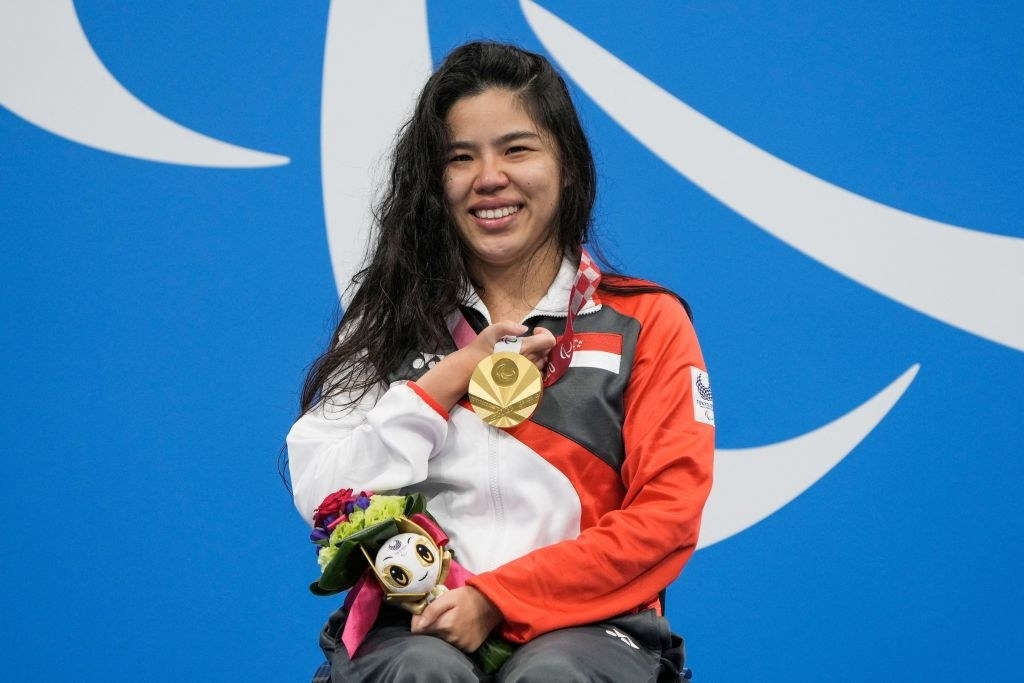 Yip Pin Xiu celebrates on the podium after the women&#x27;s 100m backstroke swimming event during the Tokyo 2020 Paralympic Games