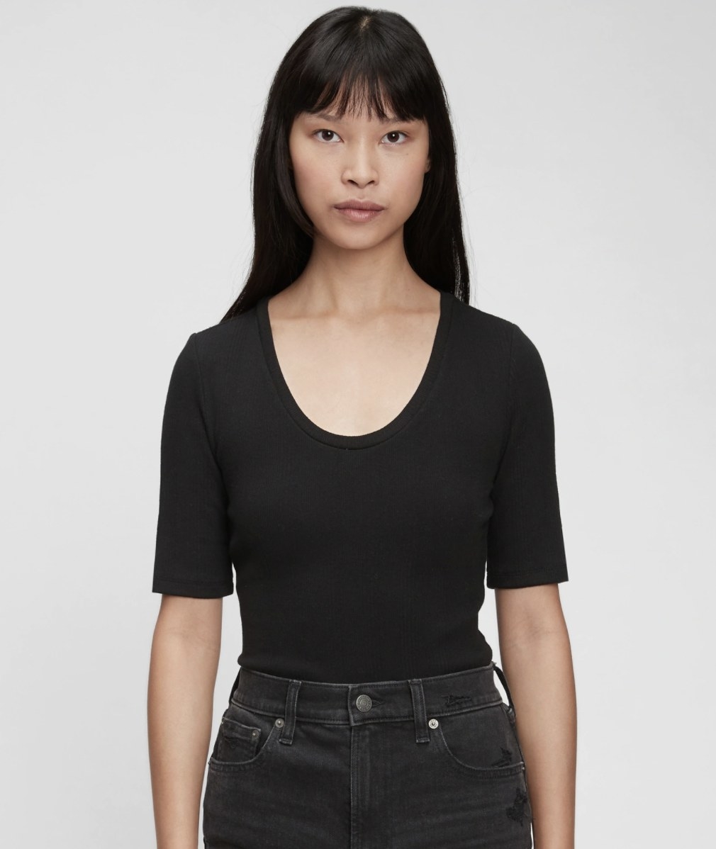 a model wearing the bodysuit in black