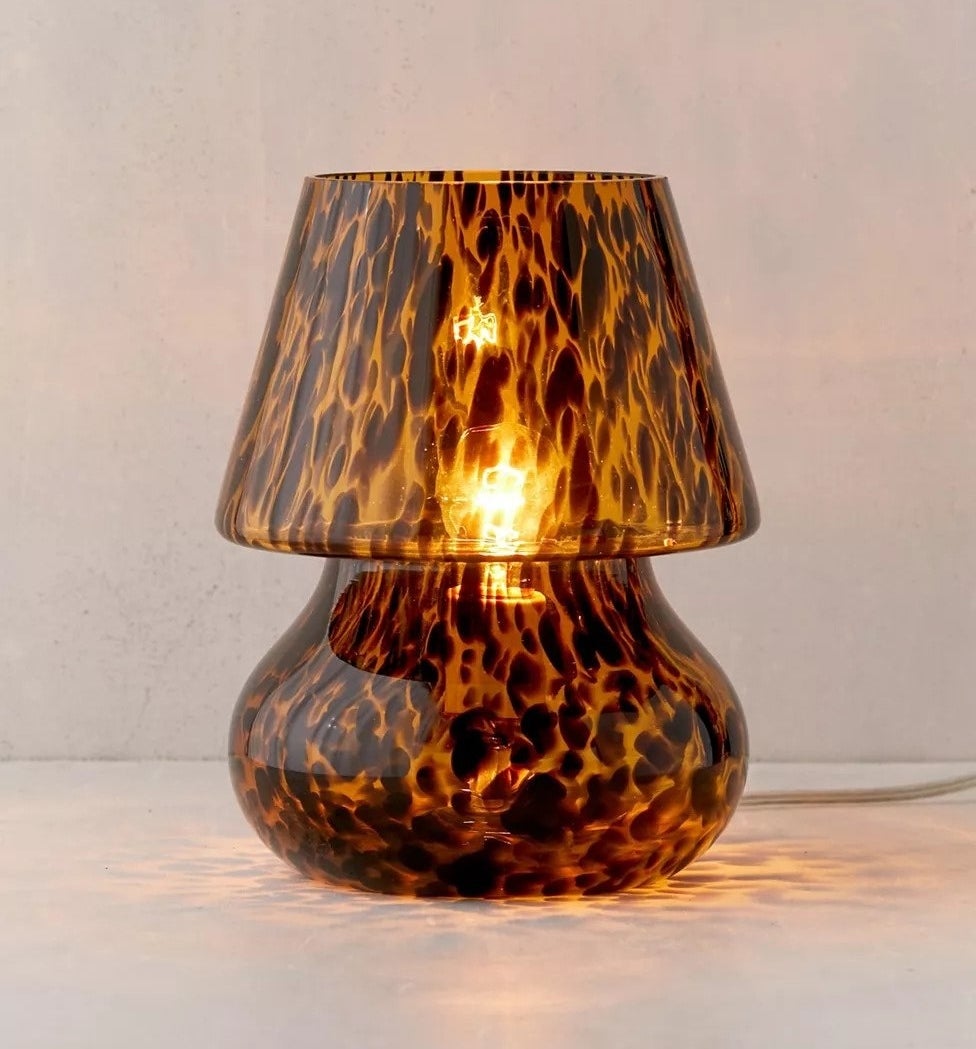 the bulbous lamp with attached shade, all made of glass, in a tortoise shell pattern 