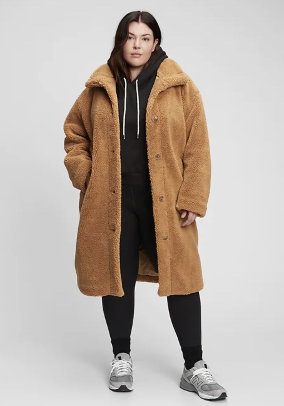 a person wearing the sherpa coat in camel