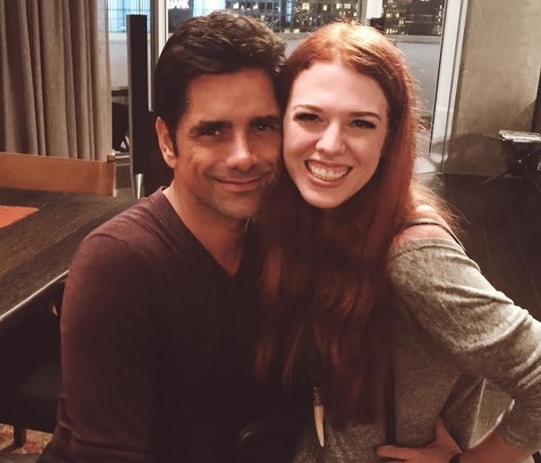 A fan posing with John Stamos on the set of &quot;Grandfathered&quot;