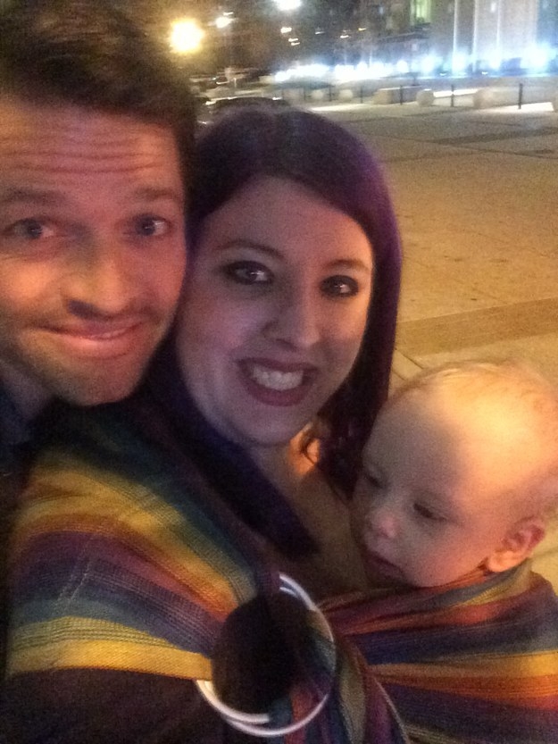 A fan with her baby posing for a selfie with Misha Collins