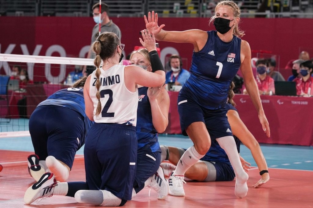 USA&#x27;s Lora Webster (R) celebrates with Bethany Zummo (2nd R) during the sitting volleyball pool match during the Tokyo 2020 Paralympic Games