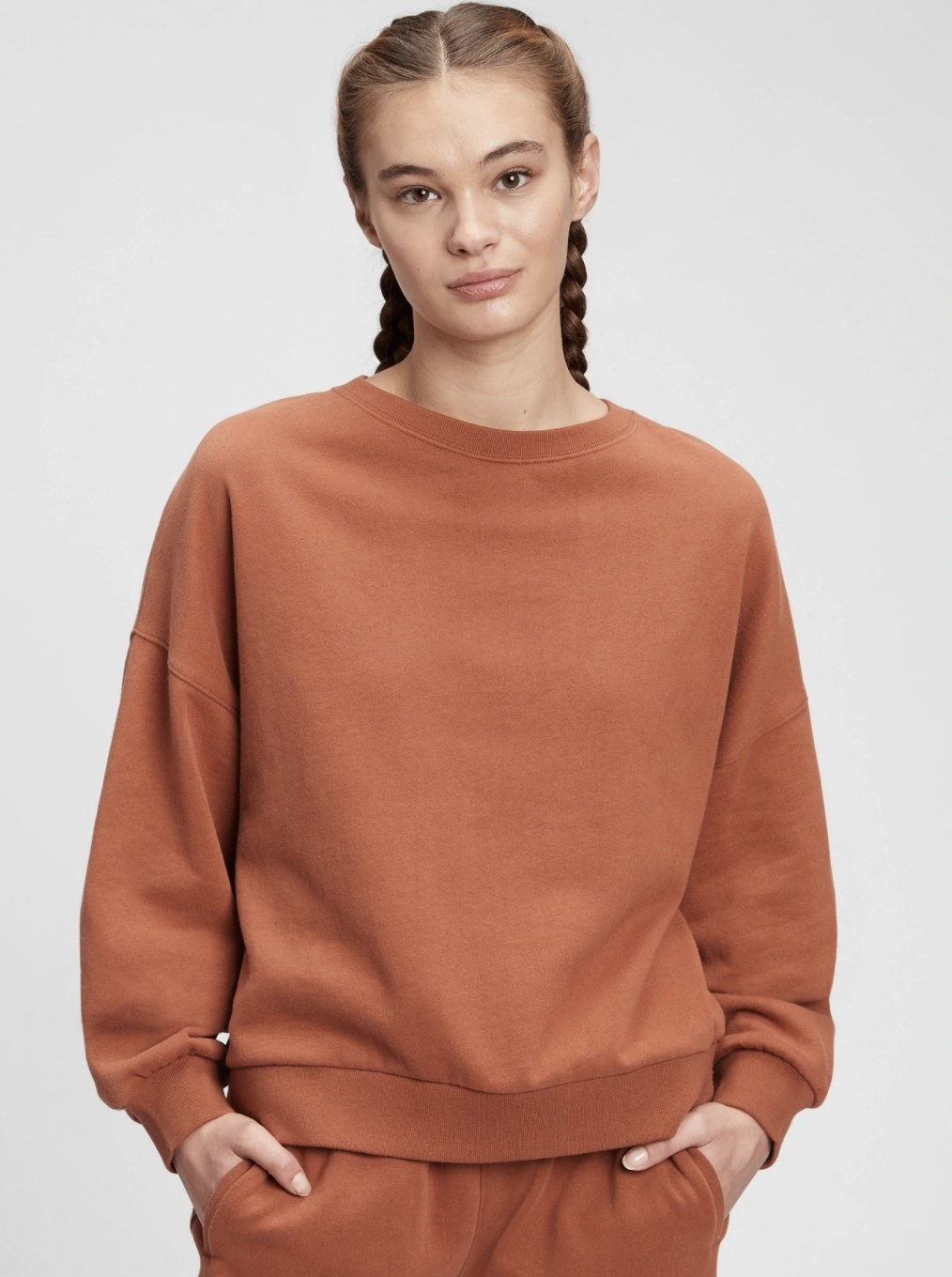 model wearing the sweater in orange