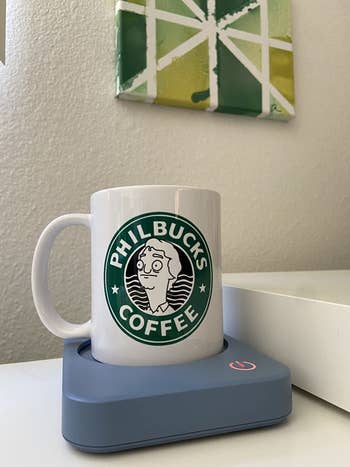 a coffee mug sitting inside the pastel blue warmer