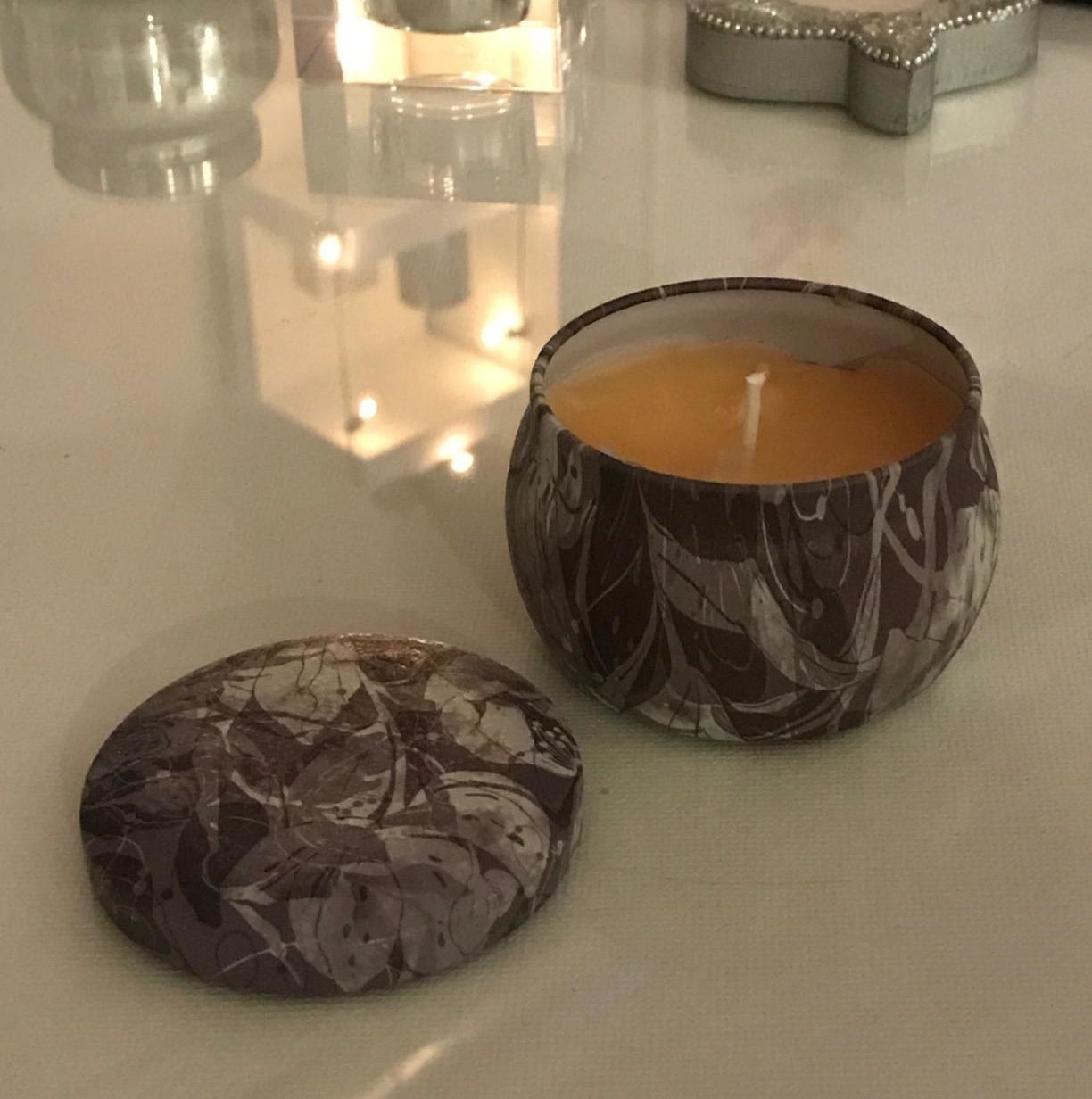 Reviewer photo of the candle tin with a candle inside