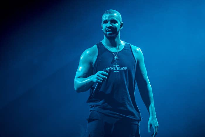 Drake in a sleeveless T-shirt performing on stage
