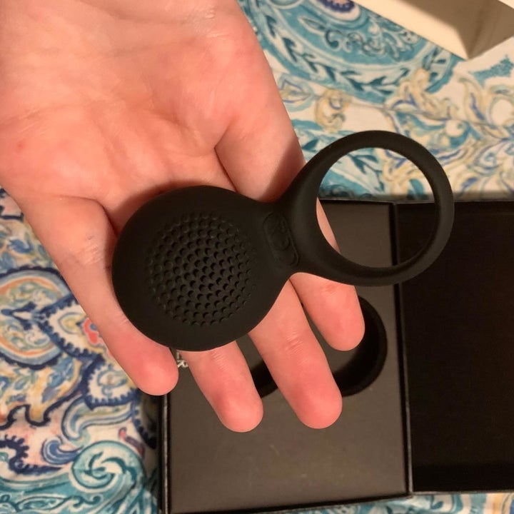 reviewer displaying textured side of cock ring
