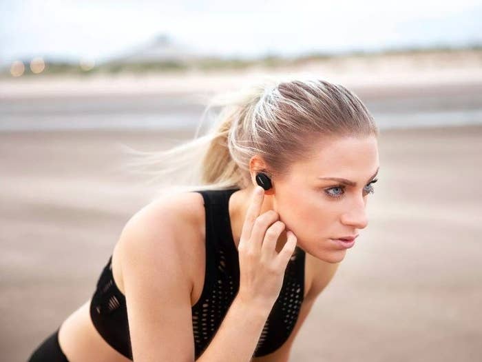 Model running with the earbuds securely in her ears