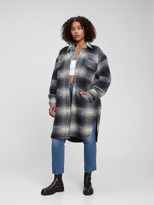 model wearing black/white plaid jacket with jeans a black boots