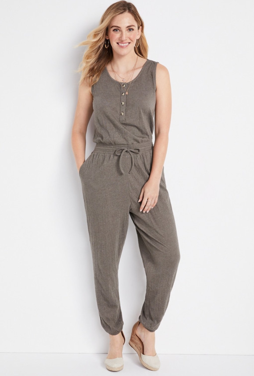 model wearing the olive jumpsuit with wedges