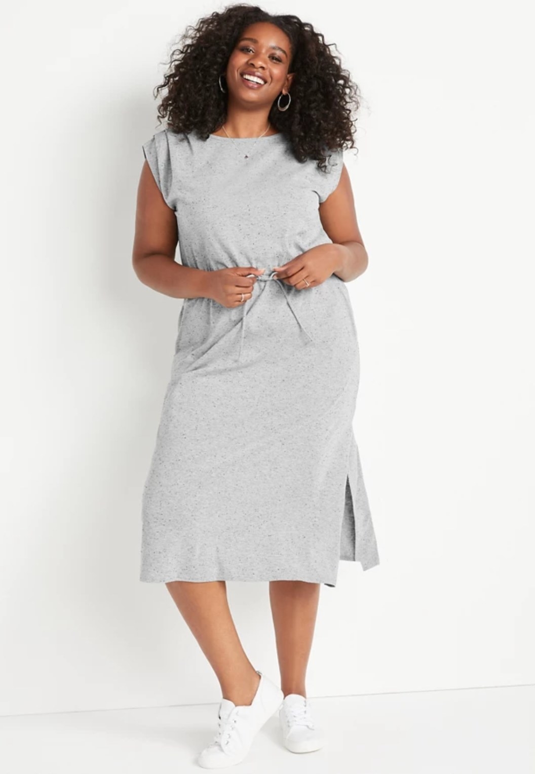 model wearing the light gray dress with white shoes
